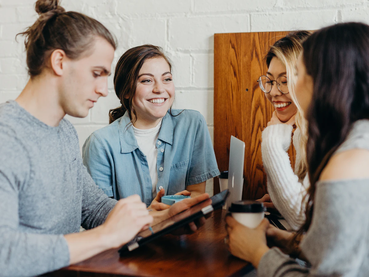 A group of friends talking over coffee at a local café